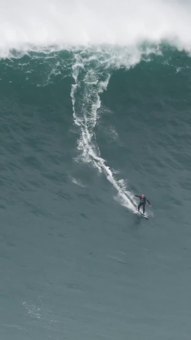 Person Rides Surfboard On High Tides