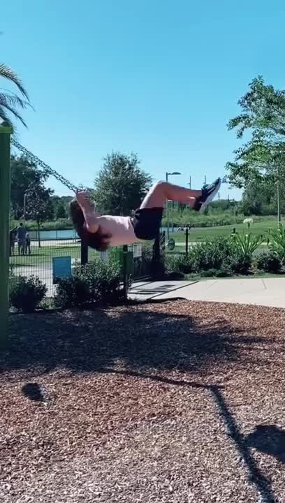 Girl Riding Kid's Swing Finishes With Backflip