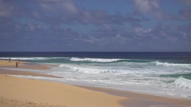 Medium Zoom Shot of Waves Crashing on Beach